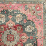 Close-up view of the Rosy Heritage Hand Tufted Rug, showcasing intricate vintage patterns in rich hues of pink, blue, and beige, ideal for a dining table setting or as a square area rug in an office space. This wool rug features classic Persian design elements, making it a perfect addition to dining room carpets or as a charming dining room centerpiece.