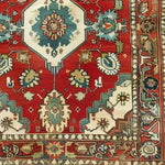 A vibrant Rosy Retreat Hand Knotted Area Rug showcasing intricate Persian-inspired patterns in rich red, blue, and cream tones. This vintage rug features floral and geometric designs, perfect for adding a touch of elegance to large living room spaces.