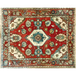 A vibrant Rosy Retreat hand knotted area rug featuring a traditional Persian design. This large living room rug showcases intricate floral patterns with rich red, blue, and cream colors, embodying a vintage rug charm perfect for enhancing your home decor.