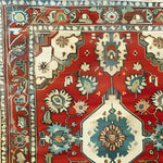 Close-up view of the Rosy Retreat Hand Knotted Area Rug, showcasing its intricate vintage Persian design. This large living room rug features a rich red background with detailed floral motifs, perfect for enhancing any space with a classic touch.
