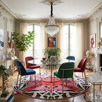 Elegant dining room with colorful butterfly round rug, and a chandelier.