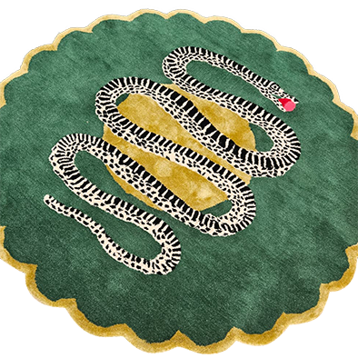 Round green scalloped wool rug with black-and-white snake winding over a golden center and red apple