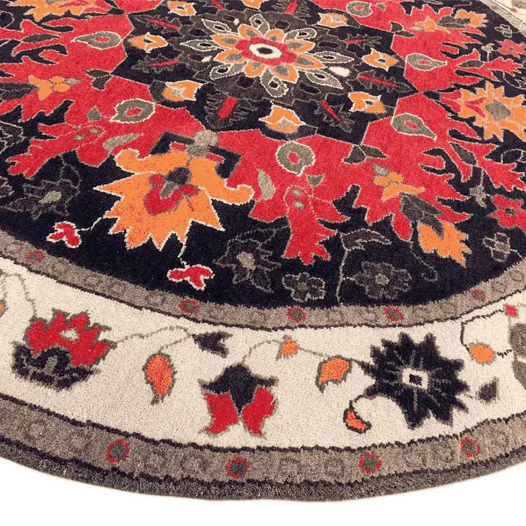 Vibrant round area rug featuring an intricate medallion design with red, orange, and black hues, perfect for enhancing bedroom decor. This wool rug, reminiscent of Persian rugs, adds a touch of elegance and warmth to any bedroom space.