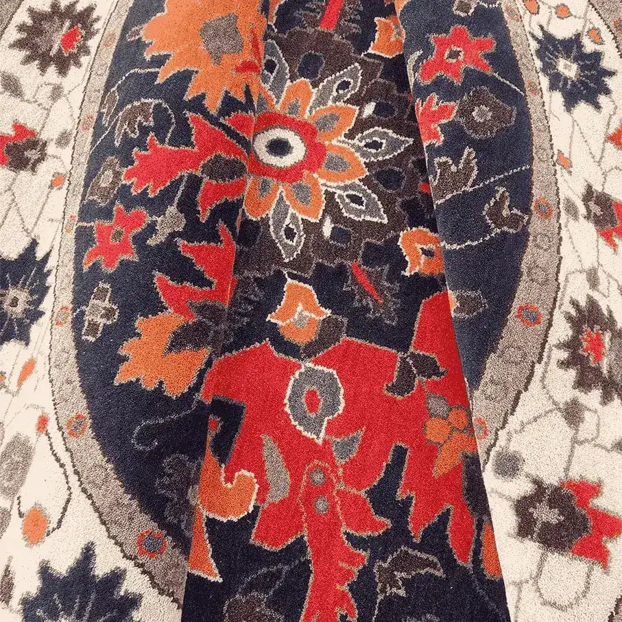 A detailed close-up view of the Round Medallion Charm Hard Knotted Area Rug, featuring intricate floral patterns in vibrant red, orange, and blue hues. This wool rug, reminiscent of Persian rugs, adds elegance to any bedroom decor.