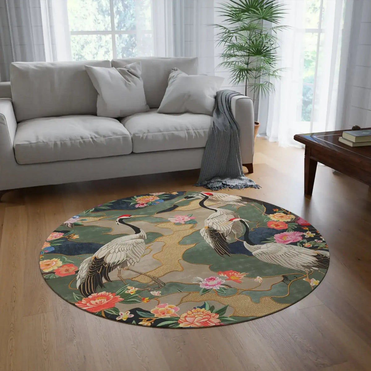 Round rug with two red-crowned cranes amid peony blooms and gold accents on a dark teal ground, Elegant Crane and Floral Pattern in a living room