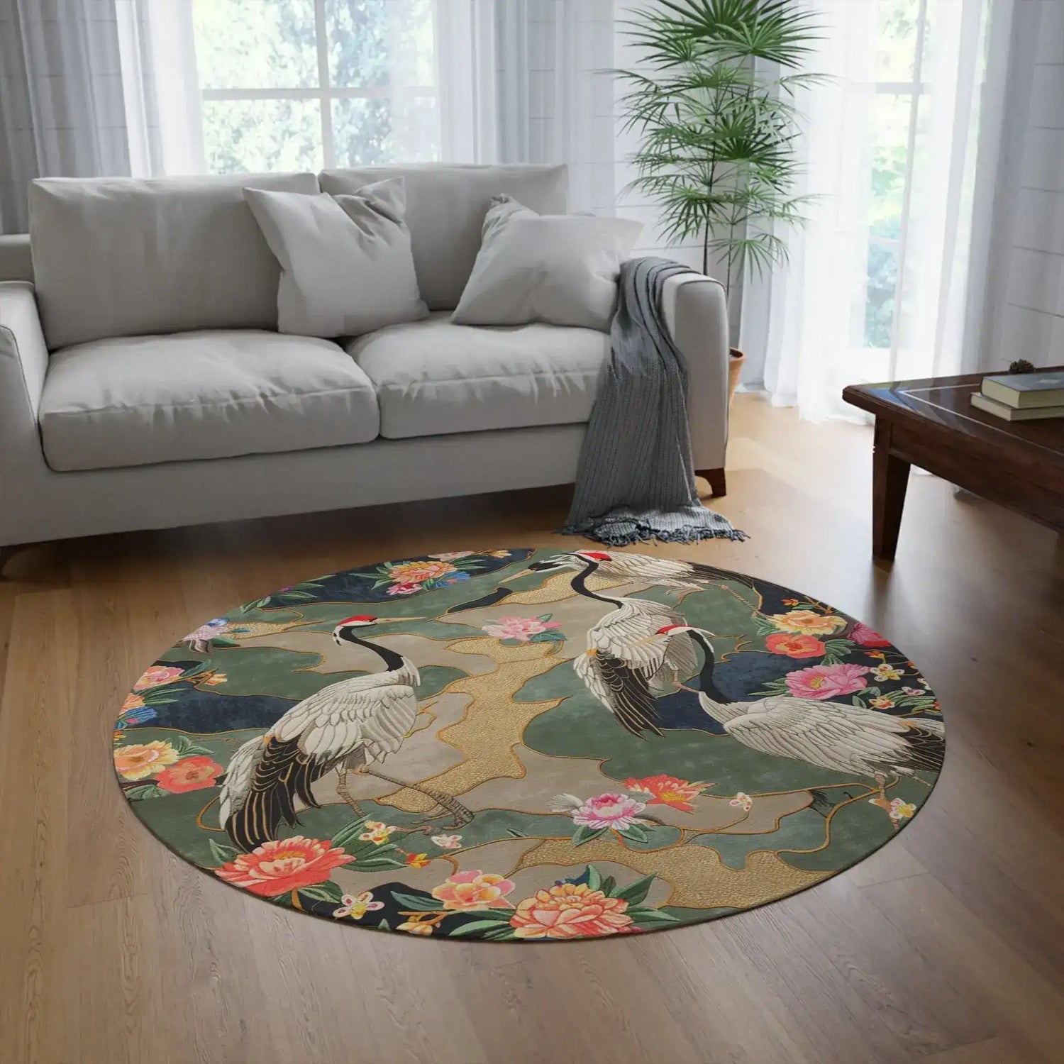 Round rug with two red-crowned cranes amid peony blooms and gold accents on a dark teal ground, Elegant Crane and Floral Pattern in a living room