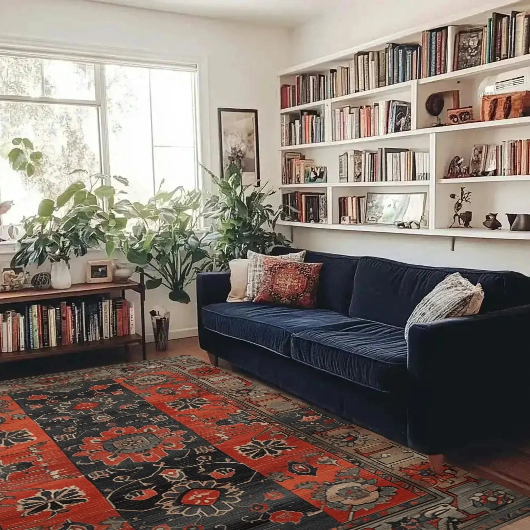 A beautifully styled living room featuring the Royal Blossom Hand Knotted Area Rug. This vintage rug adds a touch of elegance with its intricate patterns and rich colors, perfect for enhancing any living space. Complemented by a deep blue sofa and lush green plants, this Persian rug creates a warm and inviting atmosphere.