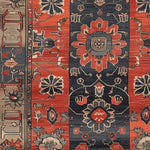 Close-up view of a Royal Blossom Hand Knotted Area Rug featuring intricate vintage patterns in rich reds and deep blues, perfect for adding a Persian rug style to your living room.