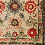 Close-up of the Royal Blossom Hand Tufted Rug showcasing its intricate floral pattern. This elegant wool area rug is perfect for large living rooms, offering a vintage touch with its 8x10 size. The detailed design features bold red and gray flowers, making it an ideal choice for those seeking large area rugs with a classic floral flair.