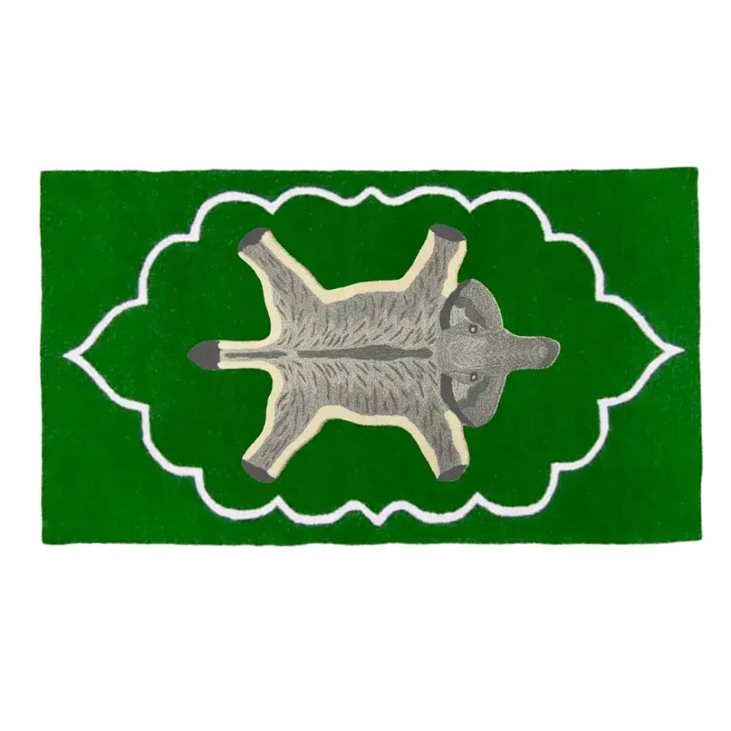 A vibrant green Royal Elephant Hand Tufted Wool Rug featuring a vintage elephant design in the center, ideal for adding a unique touch to bedrooms or offices. This area rug, with its blend of traditional and playful elements, is perfect for enhancing the decor of any space.