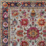 Close-up view of a Royal Flower Tapestry Hand Knotted Area Rug featuring a vibrant floral pattern. This square rug showcases intricate designs with pink, orange, and purple flowers on a vintage-style wool background. Ideal for large living rooms, this Persian-inspired floral rug adds a touch of elegance and sophistication.