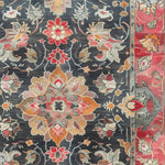 Close-up of the Royal Majesty Hand Tufted Rug showcasing a vibrant floral pattern. This beautiful area rug, perfect for a dining room or large living room, features intricate Persian designs with a rich blend of colors. Made from high-quality wool, this rug adds elegance to any formal dining room or living room setting.