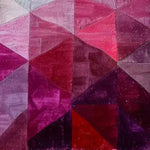 A vibrant Ruby Rhapsody Wool Runner Rug showcasing a geometric pattern in shades of red, pink, and purple. This contemporary area rug is perfect for enhancing spaces like the living room, formal dining room, or as a striking hallway runner rug. The luxurious wool texture adds warmth and style, making it an ideal choice for kitchen runner rugs or as a statement piece in any large living room.