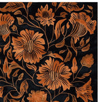 A close-up view of the Rust Reverie Hand Tufted Rug, a stunning area rug featuring an intricate floral pattern in warm rust tones against a deep black background. Perfect for adding a vintage touch to living room area rugs, this wool rug combines elegance with durability, making it an ideal choice for area rugs for living room decor.