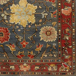 A beautifully detailed Rustic Elegance hand knotted area rug featuring intricate floral patterns set against a rich blue background. This vintage rug captures the essence of Persian rugs with its vibrant colors and elegant design, perfect for enhancing living room spaces with a touch of sophistication.