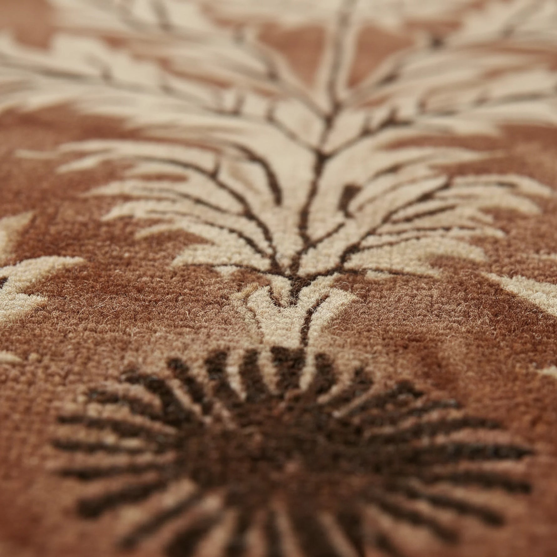 Close-up of a brown textured rug with leaf-like patterns
