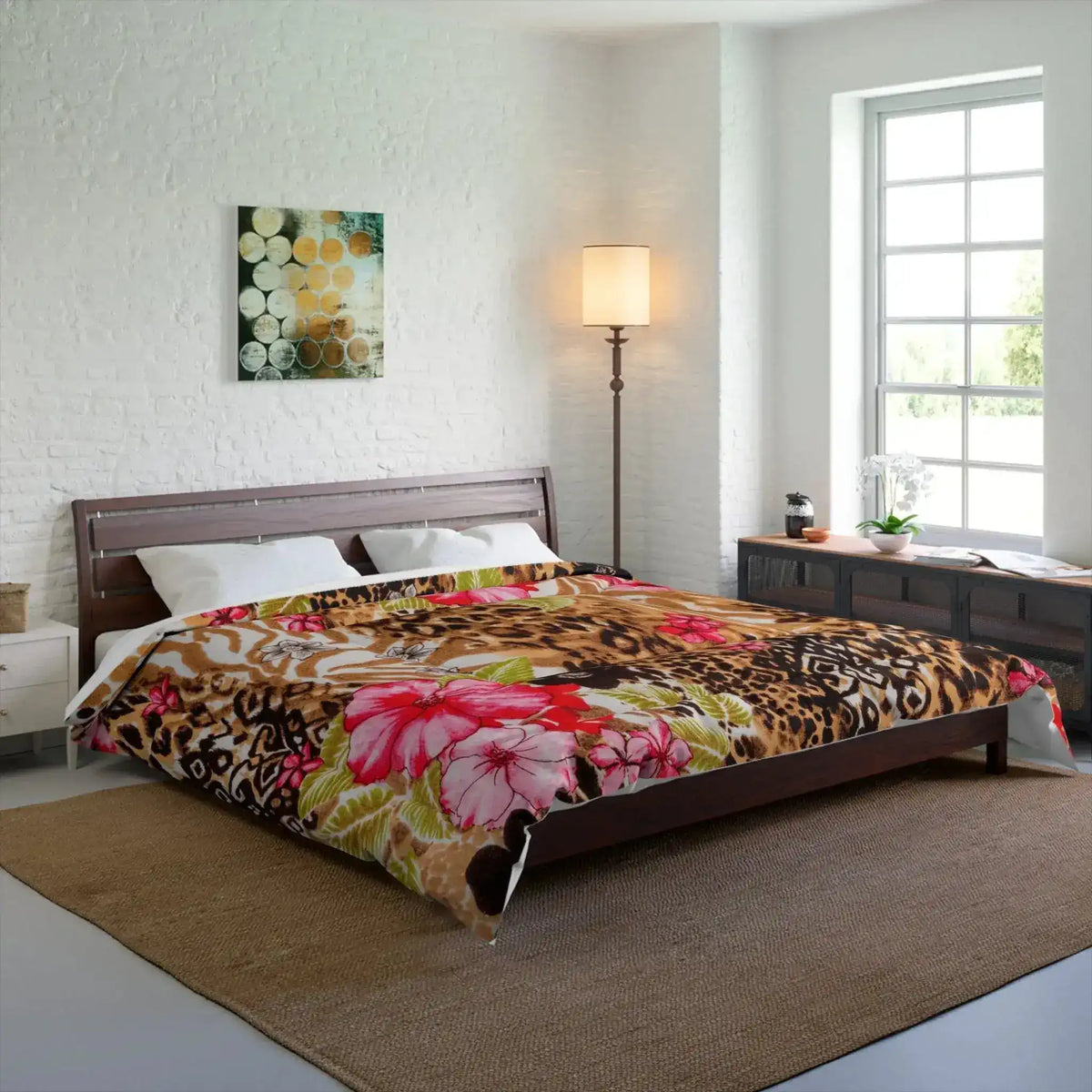 Animal-print and pink-floral comforter dressing a wooden bed in a bright white-brick bedroom with a floor lamp