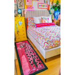 A vibrant and contemporary area rug featuring an abstract tiger design, adding a pop of color to a cozy bedroom setting. The hand-tufted wool runner rug is perfect for those looking for kitchen rugs, hallway runner rugs, or large living room rugs. The colorful patterns and soft texture make it an ideal choice for anyone seeking a unique wool rug for their living room or as a stylish bathroom runner rug.