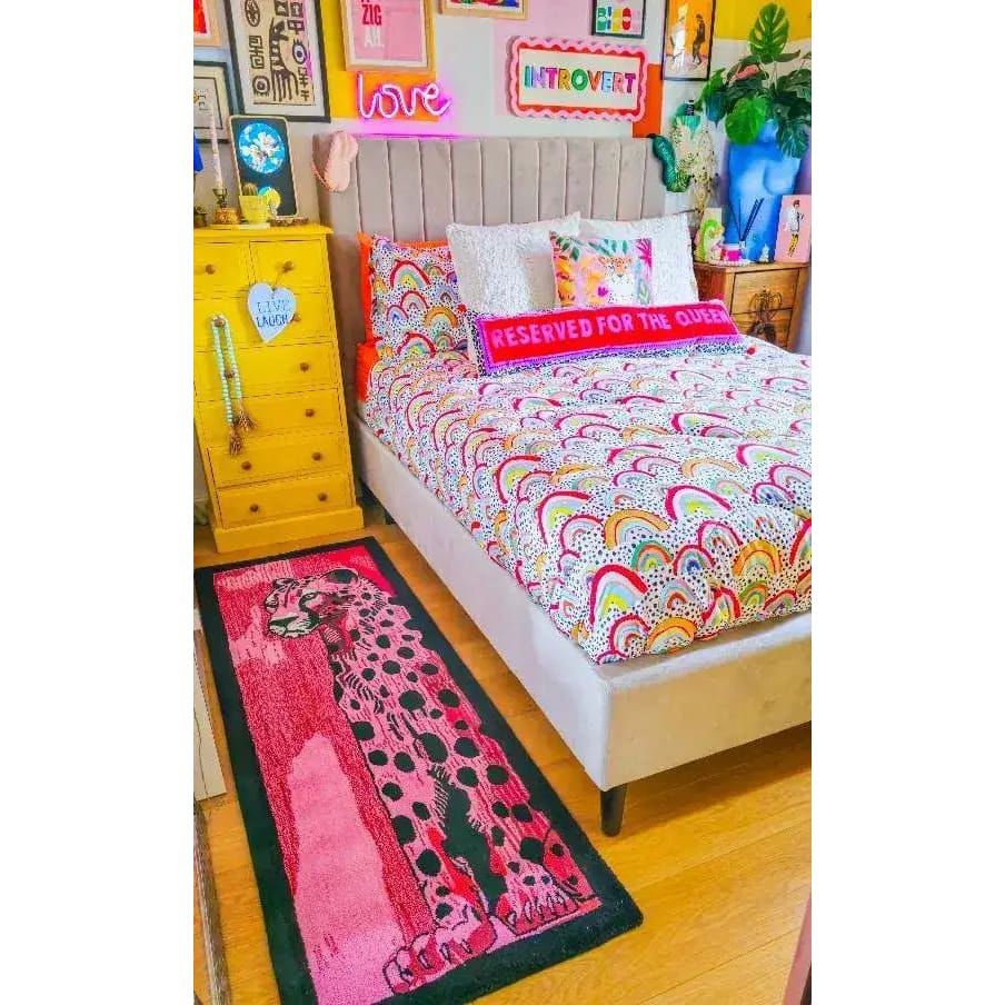 A vibrant and contemporary area rug featuring an abstract tiger design, adding a pop of color to a cozy bedroom setting. The hand-tufted wool runner rug is perfect for those looking for kitchen rugs, hallway runner rugs, or large living room rugs. The colorful patterns and soft texture make it an ideal choice for anyone seeking a unique wool rug for their living room or as a stylish bathroom runner rug.