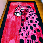 A vibrant, hand-tufted wool area rug featuring an abstract design of a pink and black spotted cheetah. This contemporary rug, perfect for a hallway runner or a bold addition to a living room, showcases intricate details and a modern aesthetic suitable for various spaces, including kitchens and bathrooms.