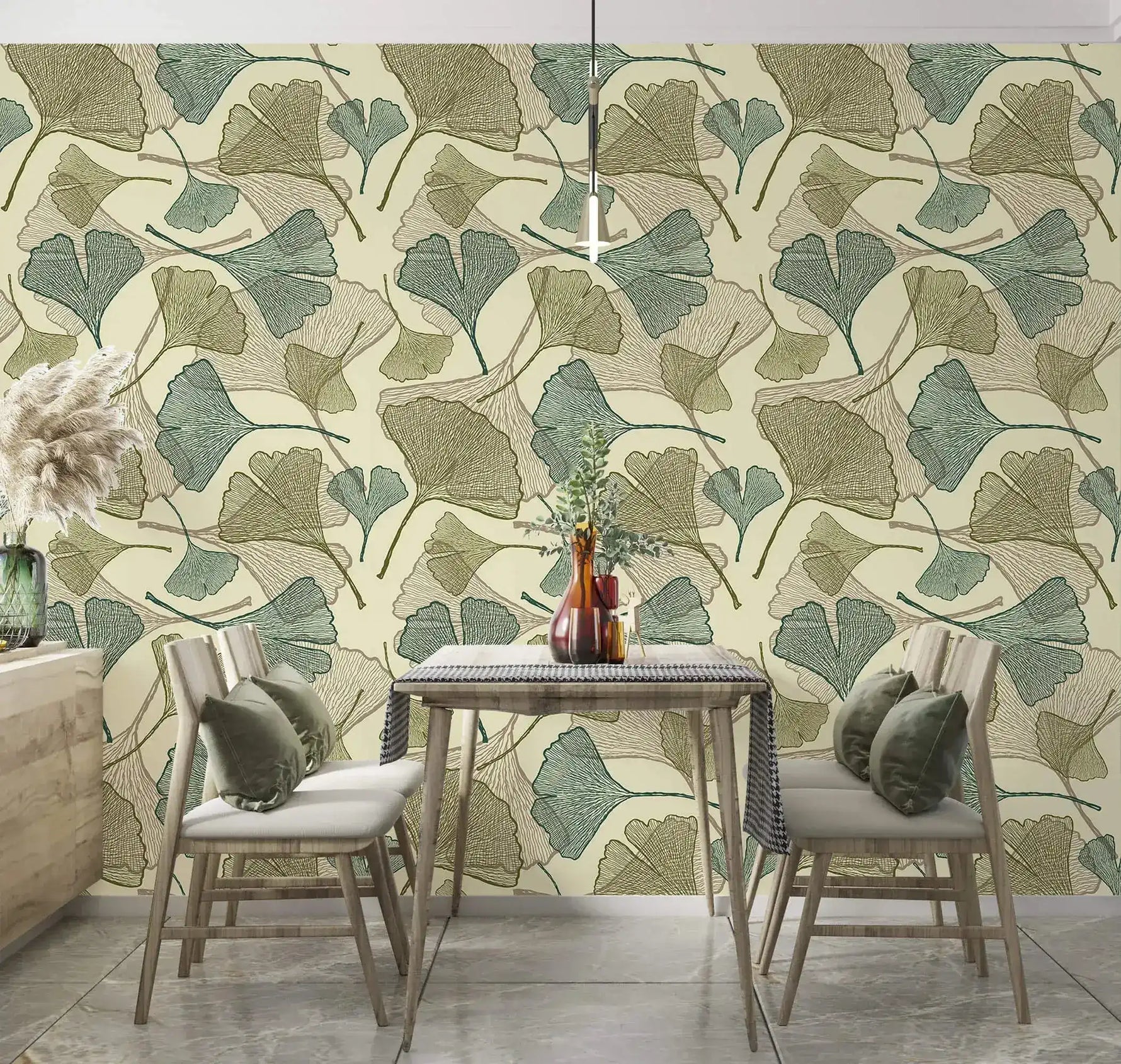 Sage and beige ginkgo leaf wallpaper in dining room with wood table, chairs and green cushions