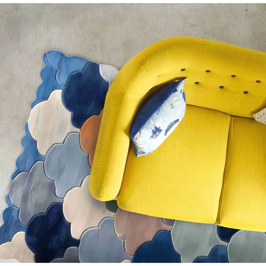 Elevate your living room or dining room with this contemporary wool area rug. The Sahara Spectrum Hand Tufted Rug features a bold, abstract design in blue and neutral tones, perfectly complementing modern and formal dining room settings. Shown beneath a vibrant yellow sofa, this dining table rug adds a touch of elegance and comfort.