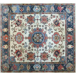 A beautifully intricate Sand and Sea Hand Knotted Area Rug featuring a vintage floral design. This Persian-style rug is perfect for adding a touch of elegance to large living rooms. The rug showcases a harmonious blend of blues, reds, and creams, making it an ideal choice for those looking for unique floral rugs or classic Persian rugs for their living room.