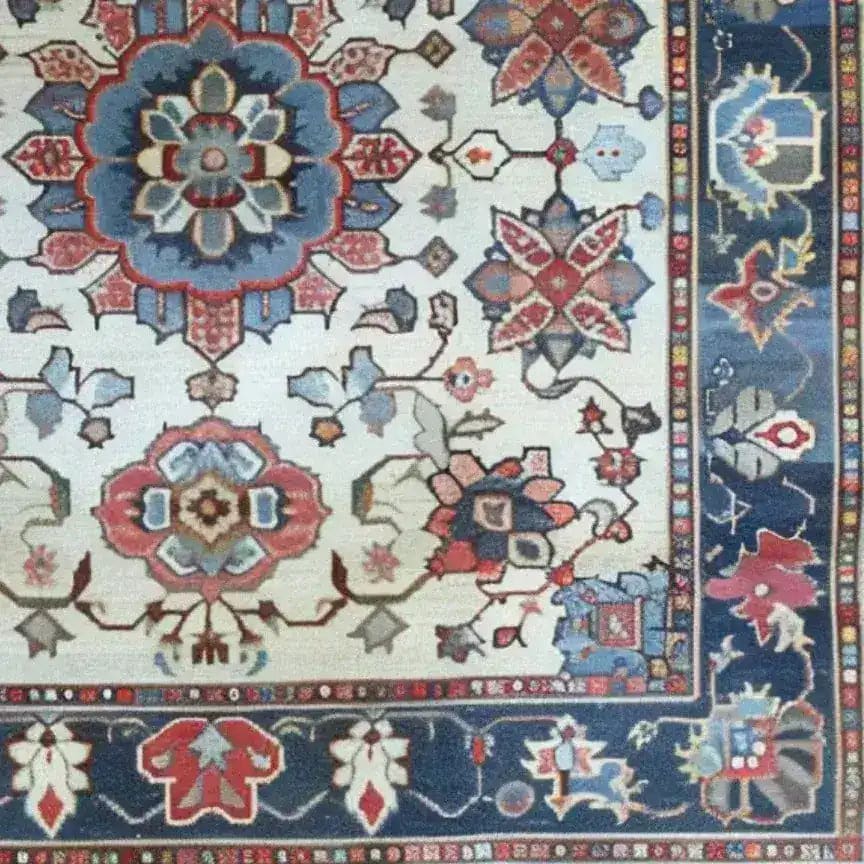 Close-up detail of the Sand and Sea Hand Knotted Area Rug, featuring an intricate floral design with vibrant colors. This vintage Persian-style rug is perfect for large living rooms, adding a touch of elegance and charm to any space.