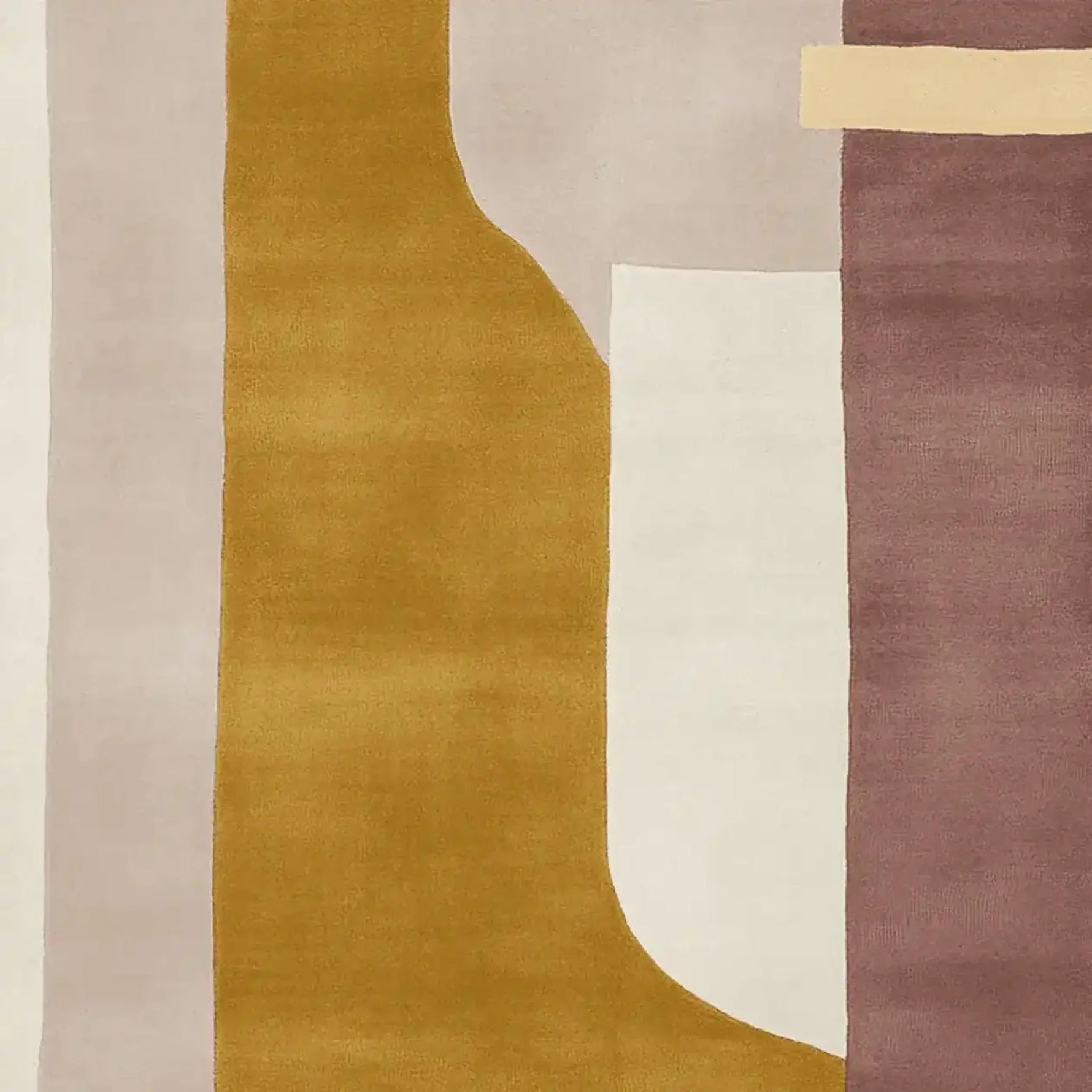 A contemporary area rug with an abstract geometric design featuring warm tones of mustard, cream, and mauve. This wool rug is perfect for large living rooms, adding a modern touch with its unique pattern and soft texture.