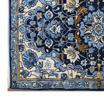 Close-up of Sapphire Arabesque Hand Tufted Wool Rug, showcasing intricate floral patterns in shades of blue and gold. Ideal for enhancing the elegance of living rooms, this area rug, sized 8x10, offers a luxurious and cozy touch.