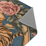 Folded corner showing large pink rose and green foliage with golden tiger body on blue-grey ground on the Savage Symphony Vintage Tapestry of Fierce Elegance