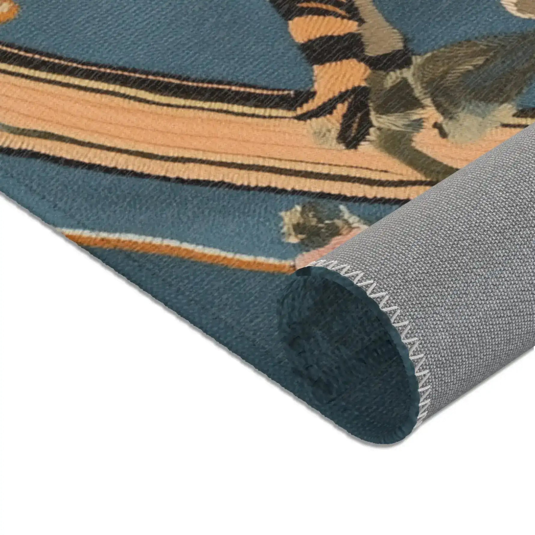Rolled bottom edge showing amber black tiger stripes and curved bamboo wreath element on slate-blue on the Savage Symphony Vintage Tapestry of Fierce Elegance