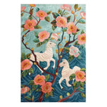 The Savanna Blossom Hand Tufted Rug showcases a vibrant floral design featuring pink blossoms and whimsical white horses against a blue backdrop. This wool area rug is perfect for adding a touch of elegance to a living room. Ideal for those seeking stylish living room rugs in an 8x10 size.