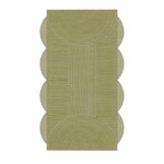 Modern living room with bookshelves, abstract art, and a geometric wool rug.