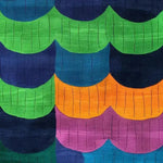 Vibrant scallop shell design on a hand-tufted wool area rug, featuring bold colors like green, blue, orange, and purple. Perfect for contemporary dining rooms or large living spaces, this rug adds a splash of color and style.