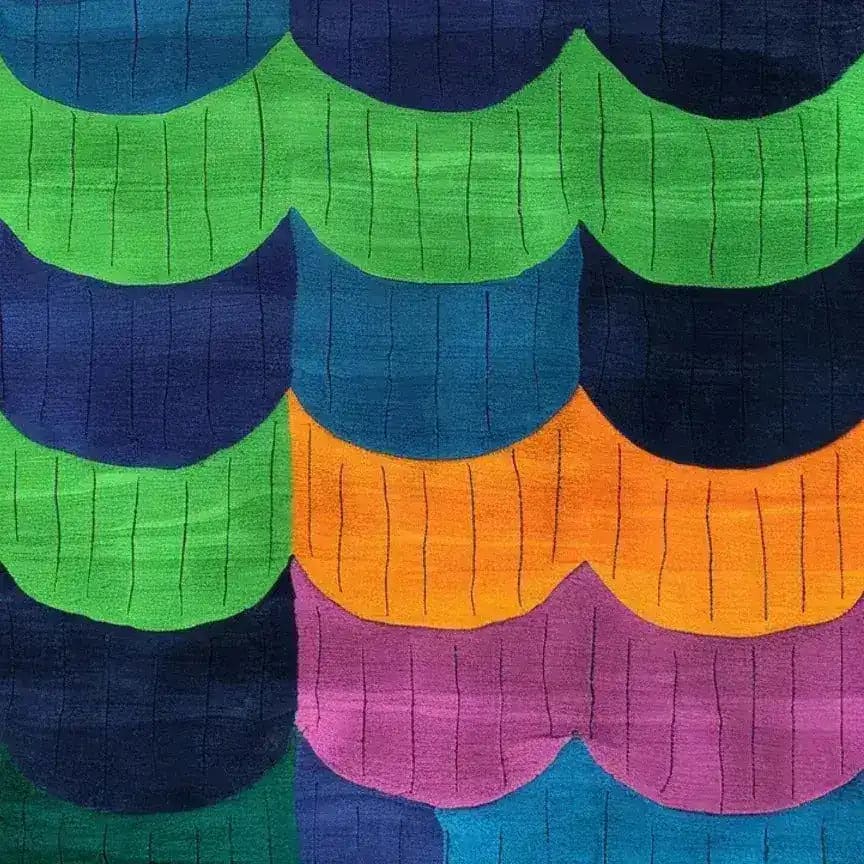 Vibrant scallop shell design on a hand-tufted wool area rug, featuring bold colors like green, blue, orange, and purple. Perfect for contemporary dining rooms or large living spaces, this rug adds a splash of color and style.