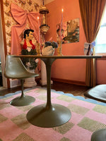 A stylish living room featuring a Scalloped Leaf Checker Pastel Hand Tufted Rug. This large area rug, perfect for a boho-inspired space, showcases a beautiful blend of pink and green checkered patterns with a scalloped border. The wool rug adds a cozy touch to the room, complementing the modern furniture and eclectic decor. Ideal for enhancing large living rooms with a touch of elegance and comfort.