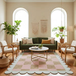 Living room with green sofa, checkered rug, and decorative plants.