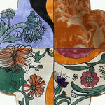 A vibrant Scalloped Meadow Hand Tufted Round Rug featuring an abstract floral design. The wool rug showcases bold colors like orange, purple, black, and green, ideal for large area rugs in a living room. This 8x10 living room rug adds a touch of elegance and nature-inspired beauty to your home decor.