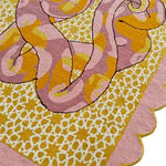 This vibrant area rug features a unique scalloped serpentine design in pink and yellow hues, perfect for adding a touch of elegance to any bedroom or living room. Hand-tufted from high-quality wool, this rug is ideal for those looking for stylish bedroom rugs or living room area rugs.