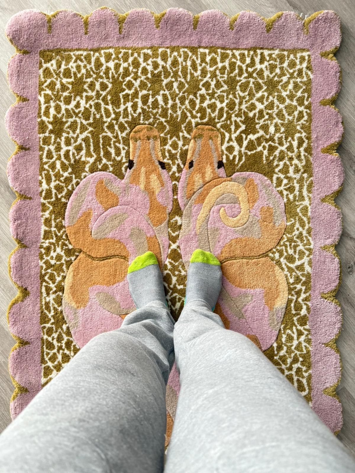 Person wearing socks stepping onto a decorative rug with butterfly design
