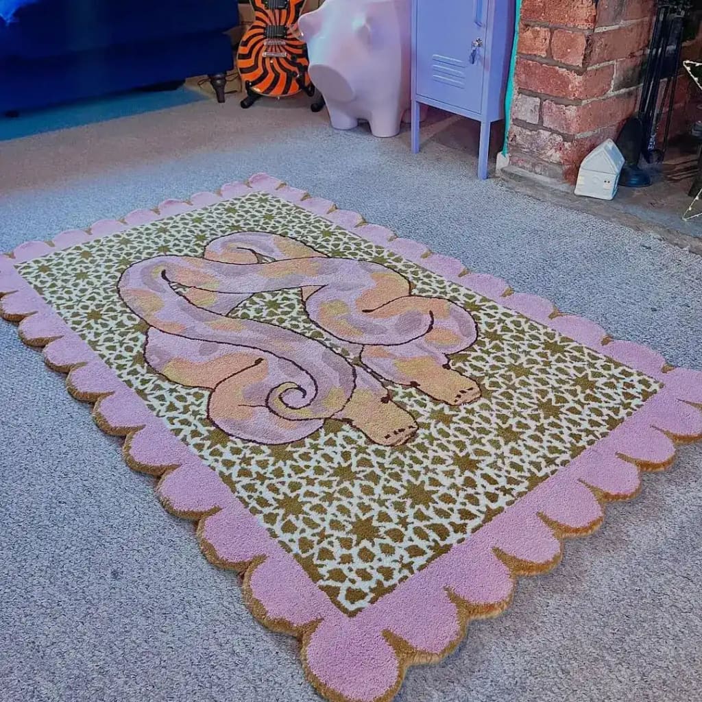 A beautifully designed area rug featuring a scalloped edge and an abstract serpentine pattern in soft pinks and greens. Ideal for adding a touch of elegance and warmth to any bedroom or living room, this hand-tufted wool rug is perfect for use as a bedroom rug or living room area rug, enhancing the cozy ambiance of your space.