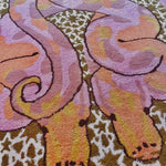 Close-up view of the Scalloped Serpentine Duo Harmony Hand Tufted Area Rug, showcasing its vibrant wool design. Perfect for adding a touch of elegance to bedrooms or living room areas, this rug features charming serpentine patterns in shades of pink, orange, and yellow.