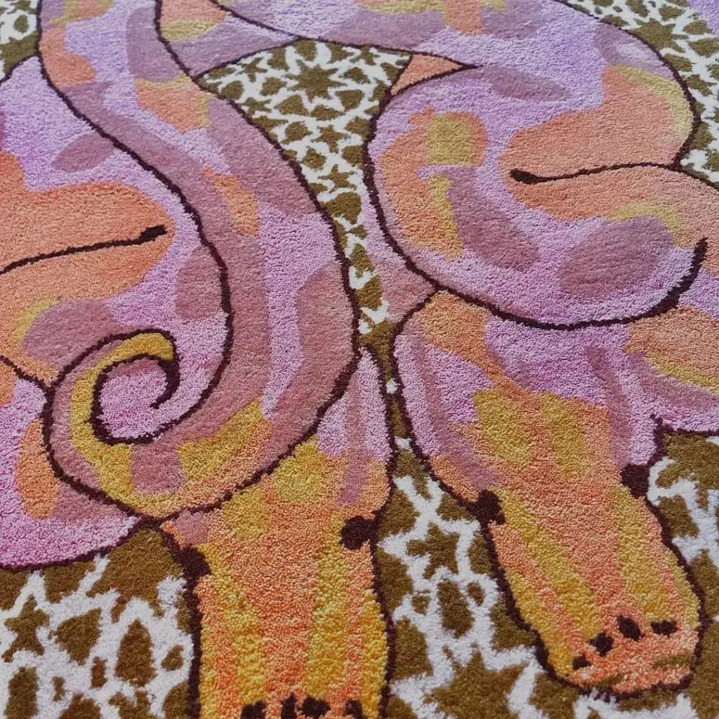 Close-up view of the Scalloped Serpentine Duo Harmony Hand Tufted Area Rug, showcasing its vibrant wool design. Perfect for adding a touch of elegance to bedrooms or living room areas, this rug features charming serpentine patterns in shades of pink, orange, and yellow.
