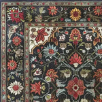 A beautifully detailed Scarlet Grove Hand Knotted Area Rug featuring an intricate floral design with vibrant red, orange, and yellow flowers on a dark background. Ideal for adding a vintage touch to your living room, this 8x10 Persian-inspired rug showcases the elegance of traditional living room area rugs.