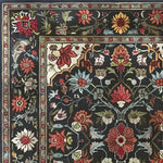 A beautifully detailed Scarlet Grove Hand Knotted Area Rug featuring an intricate floral design with vibrant red, orange, and yellow flowers on a dark background. Ideal for adding a vintage touch to your living room, this 8x10 Persian-inspired rug showcases the elegance of traditional living room area rugs.