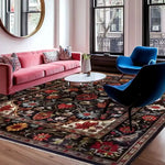 A beautifully decorated living room featuring the Scarlet Grove Hand Knotted Area Rug. This elegant floral rug with vintage Persian design showcases rich, vibrant colors in an 8x10 size, perfect for adding a touch of luxury to your living room. The area rug complements the modern decor with a pink sofa, blue chairs, and a round coffee table, adding a timeless, sophisticated charm.