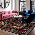 A beautifully decorated living room featuring the Scarlet Grove Hand Knotted Area Rug. This elegant floral rug with vintage Persian design showcases rich, vibrant colors in an 8x10 size, perfect for adding a touch of luxury to your living room. The area rug complements the modern decor with a pink sofa, blue chairs, and a round coffee table, adding a timeless, sophisticated charm.
