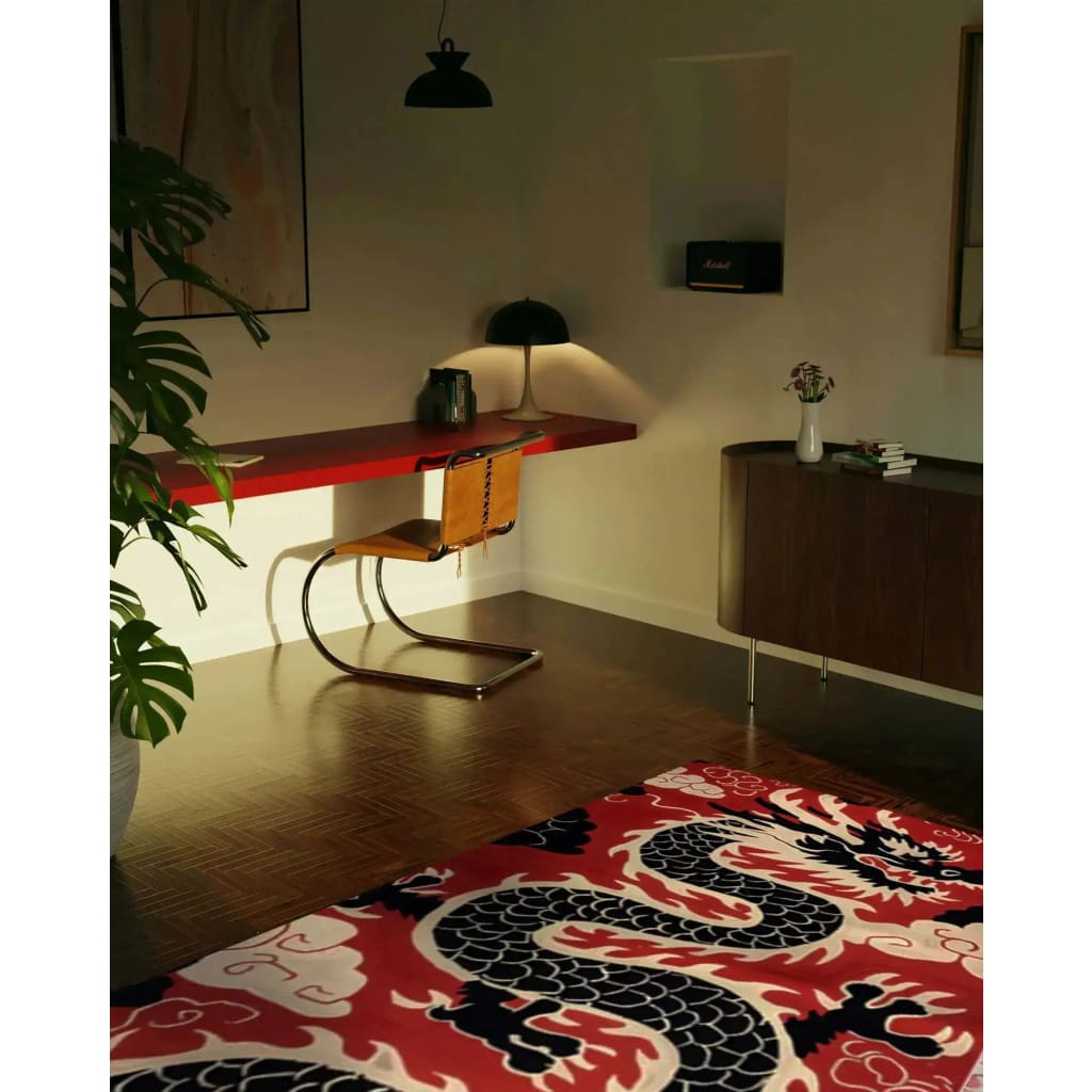 A stylish office setting featuring a Scarlet Shadow Dragon Hand Tufted Area Rug with a bold dragon design in rich red, black, and white. Ideal for adding flair to office spaces, this wool rug serves as a striking piece among large area rugs for living rooms or offices.