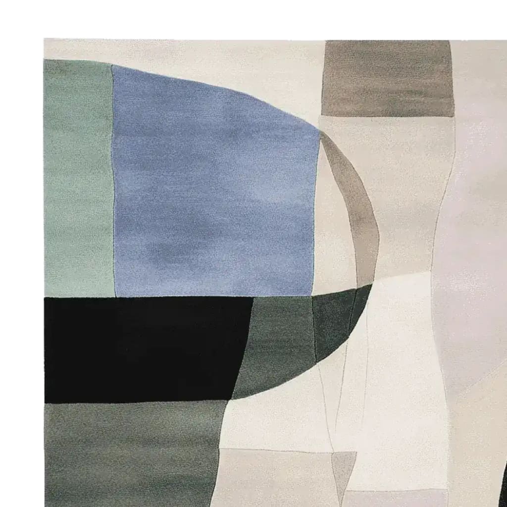 A close-up view of the Sculpted Haze Blocks Hand Tufted Rug, showcasing its contemporary design with abstract geometric patterns in muted tones of blue, green, and beige. This wool rug is perfect for adding a modern touch to any living room space, making it an ideal choice for area rugs.